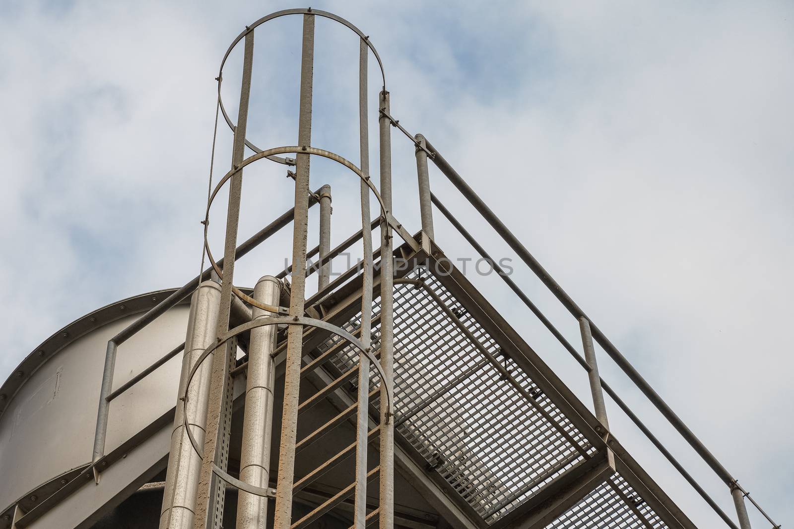 upper part of an industrial building with stairs, railings and other safety features