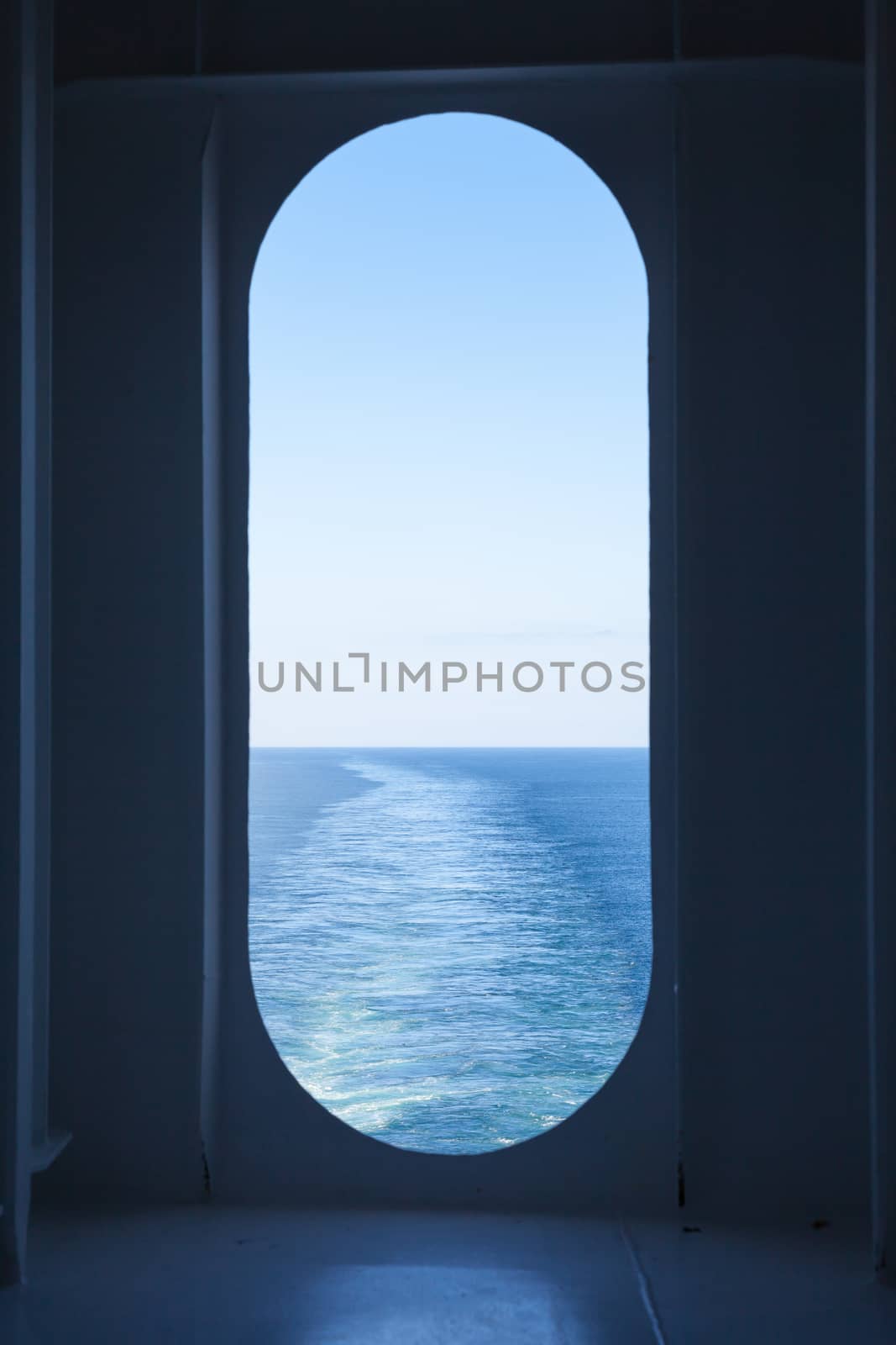 The view from a ship's stern as it travels across the ocean.