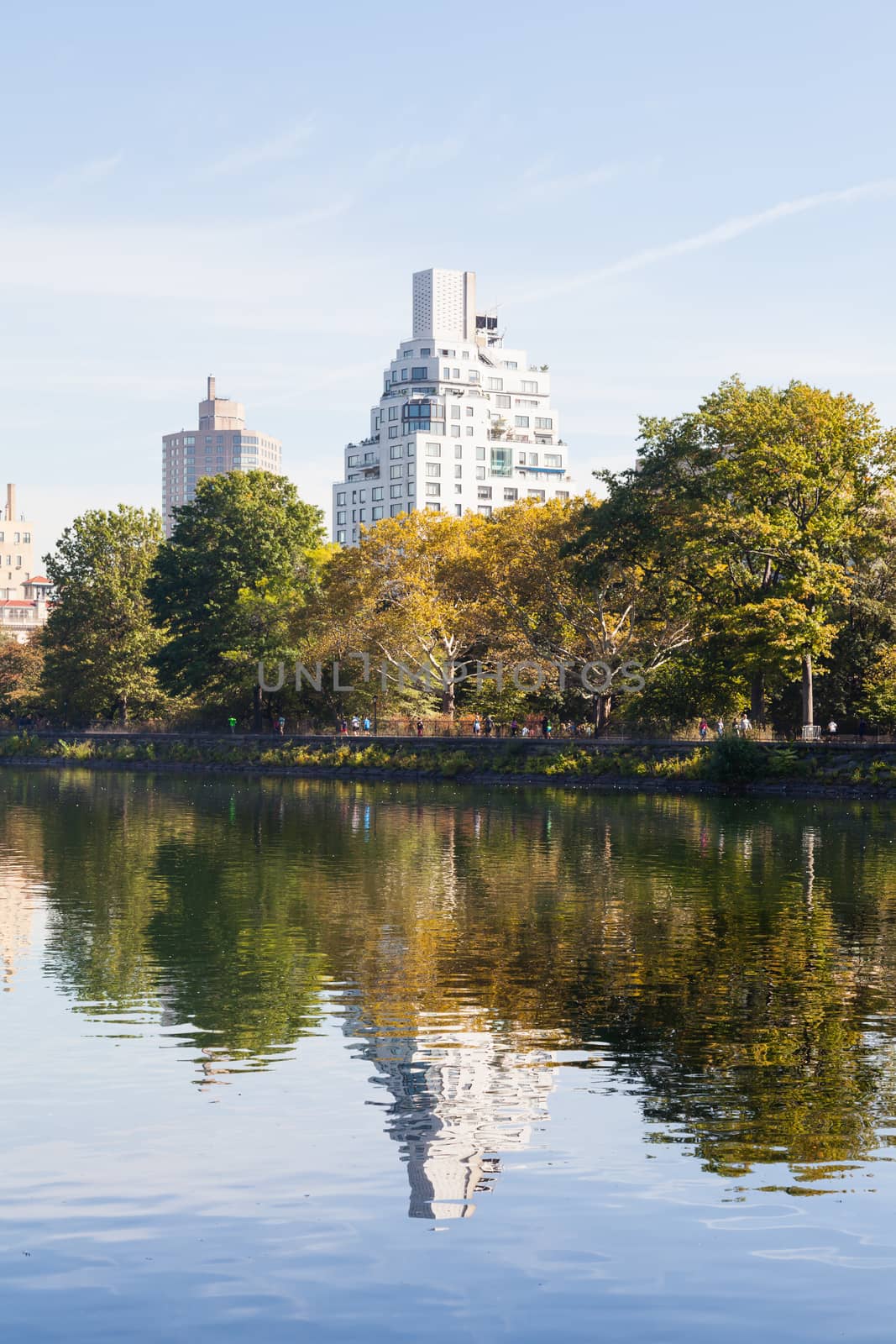 The view across the Jackie Onassis Reservoir in Central Park, New York City on a still autumn morning.