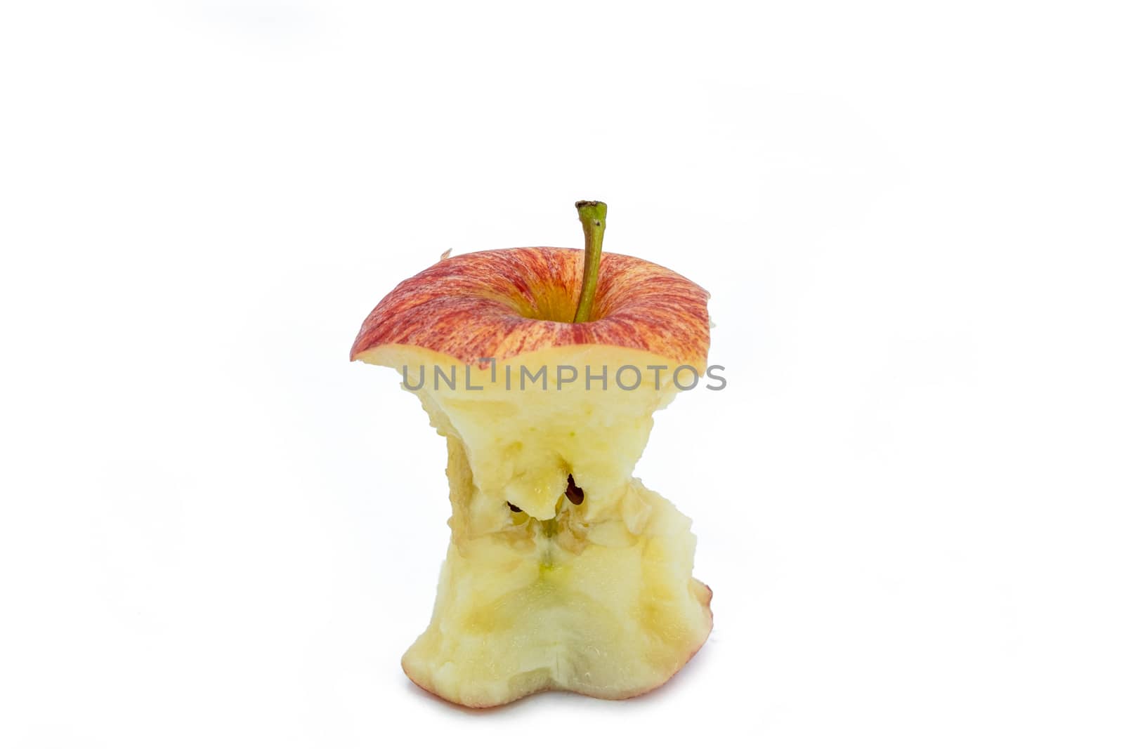 Ripe red apple core after Bitten on white background by peerapixs