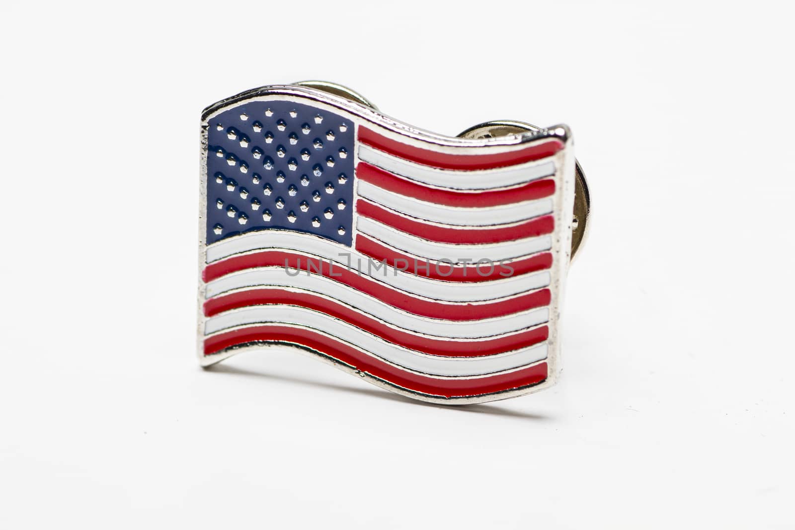 side view of a USA flag pin on a white background
