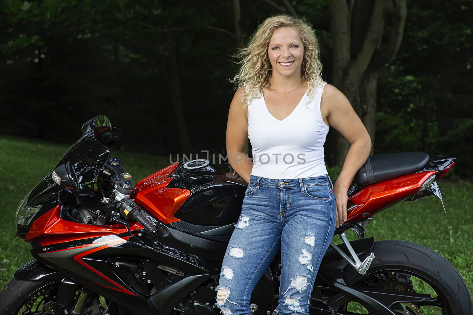Young woman leaning on a sport motocyle