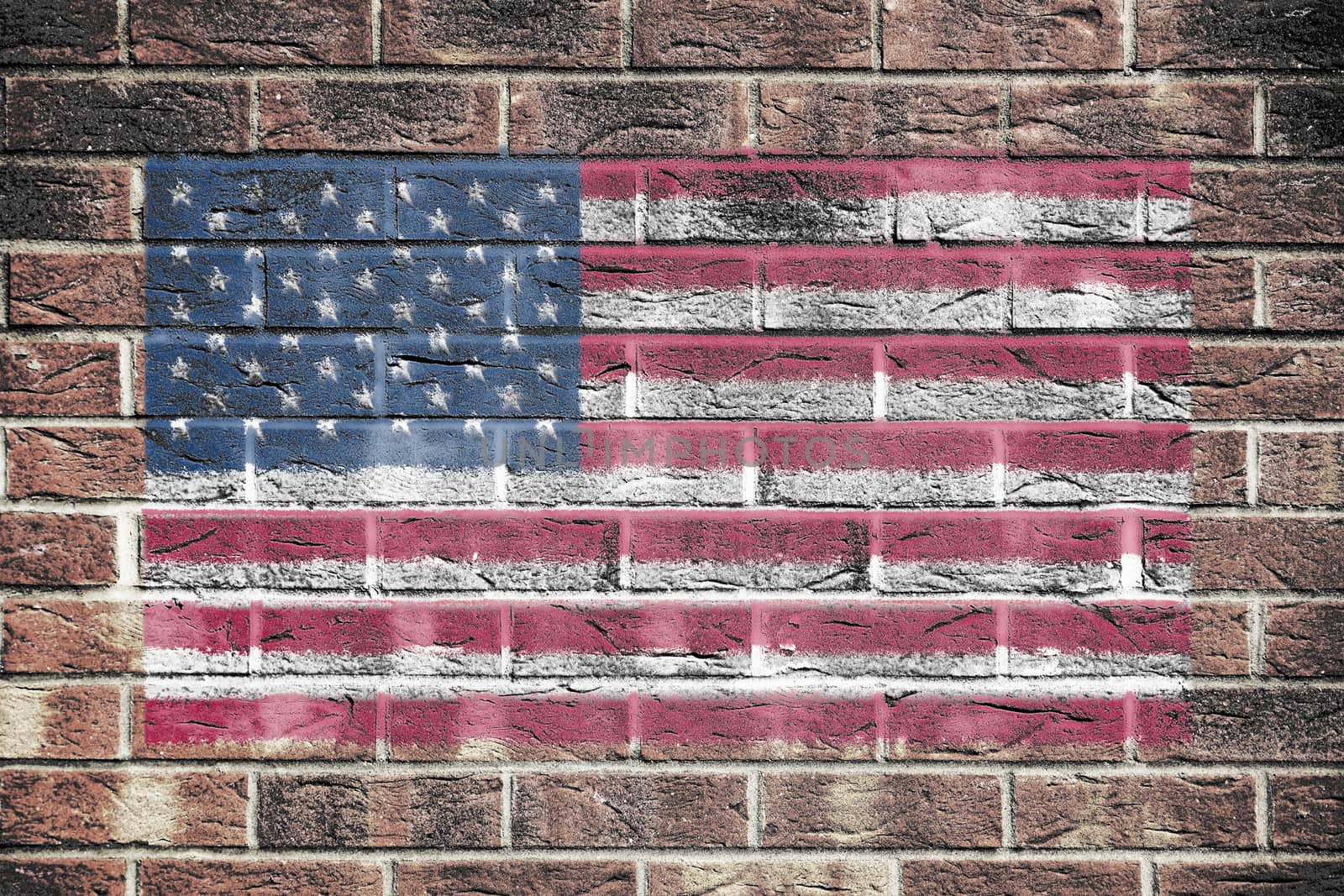 A United States of America flag stars and stripes old glory on brick wall background