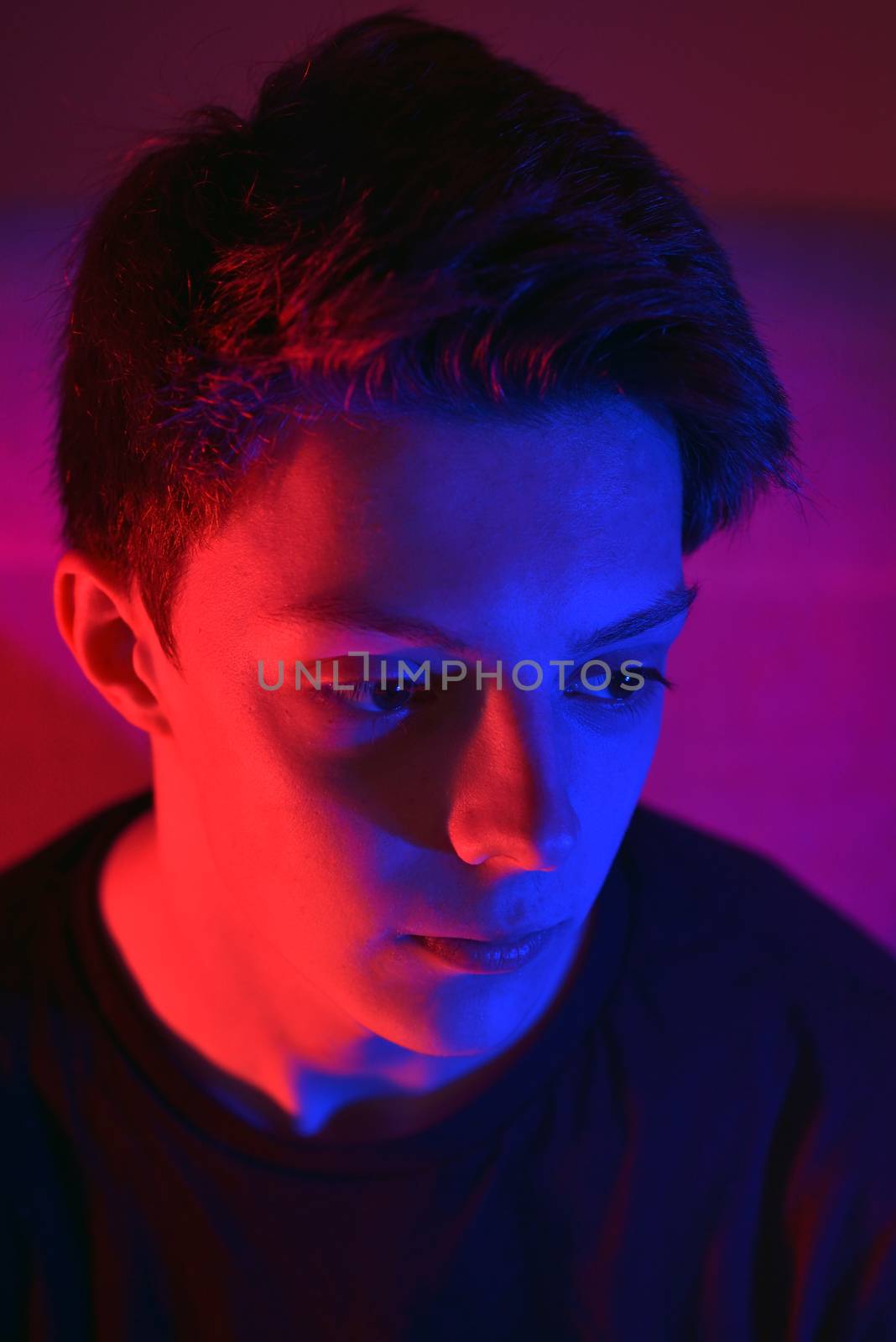 Portrait Of A Young man Under Coloured Gel Lights