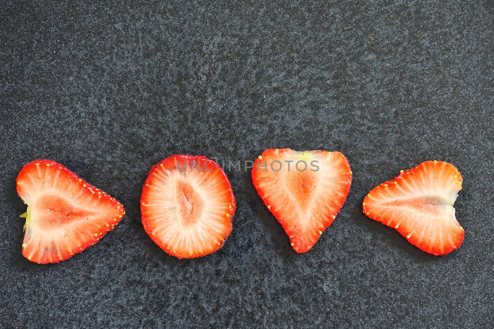 Strawberry Slices Isolated On Black Background by mady70