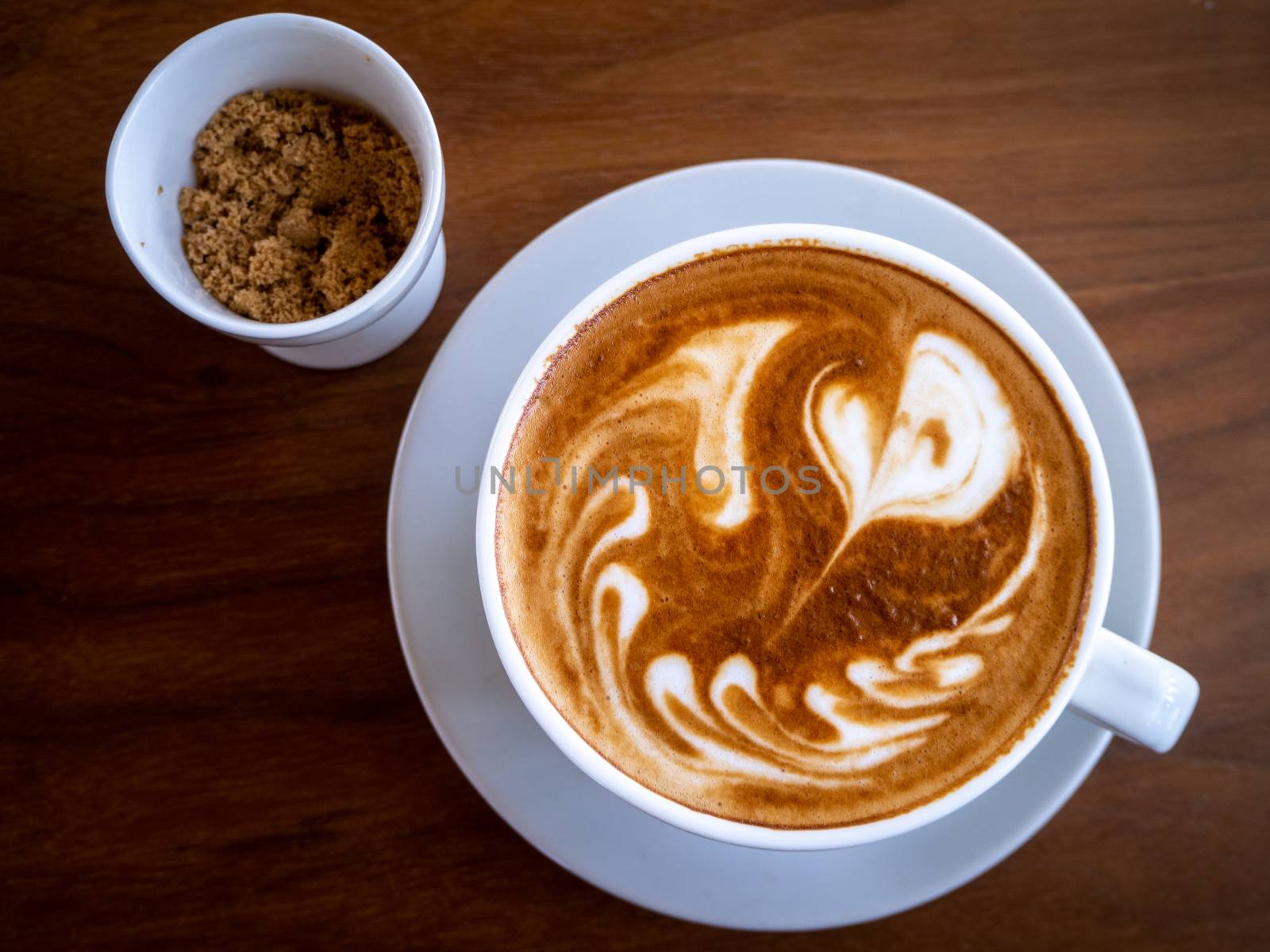 Coffee cup latte art on wood table