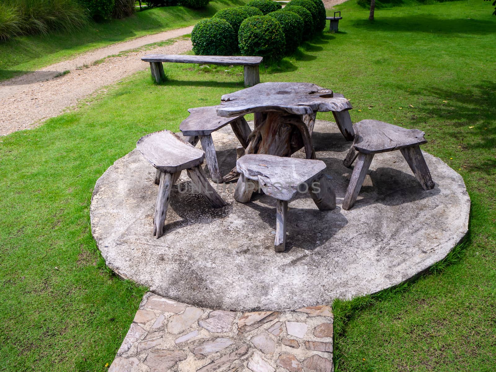 Old wooden table set  in the green garden.