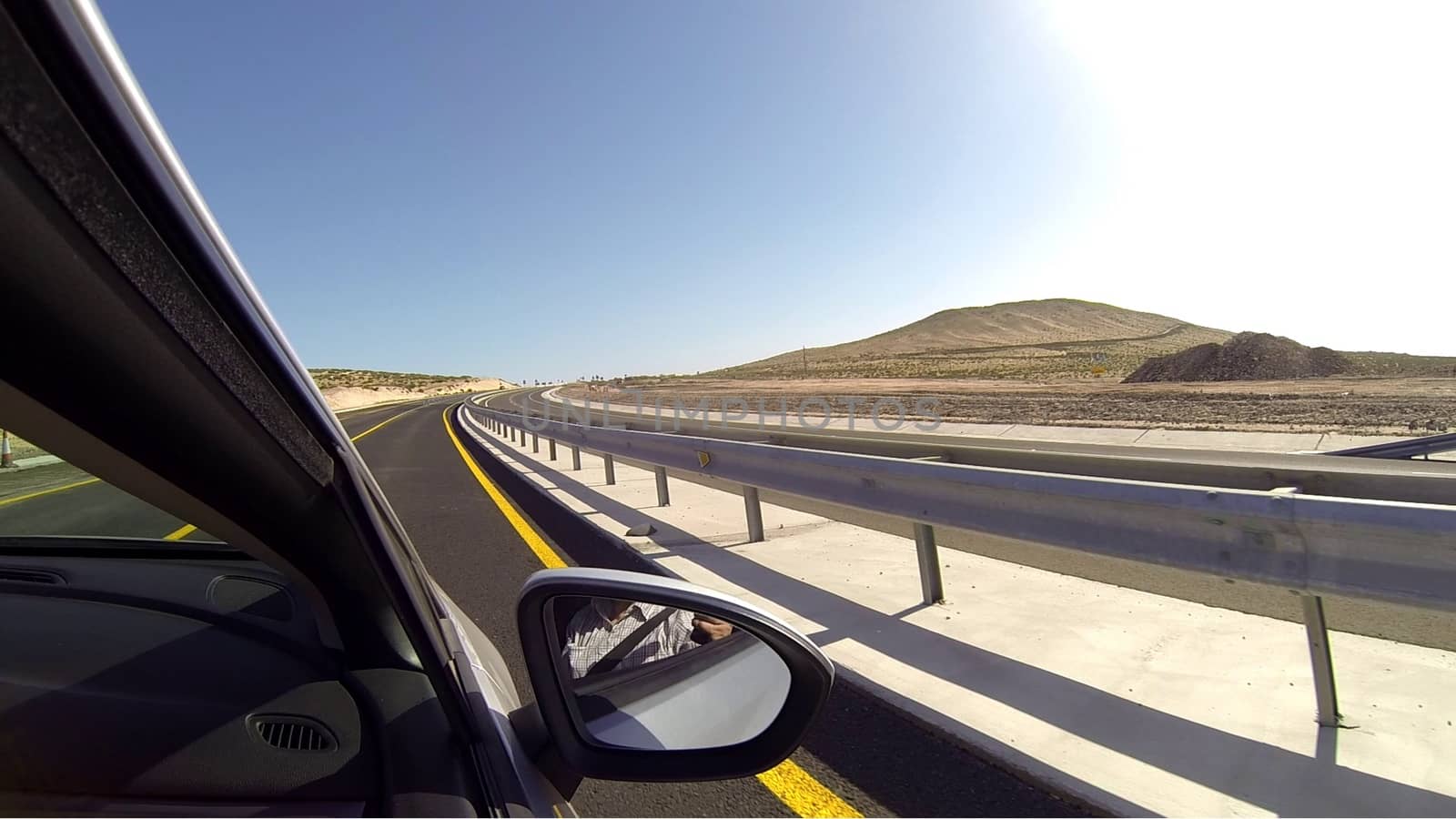 desert drive from car window - fuertaventura canary islands modern highway