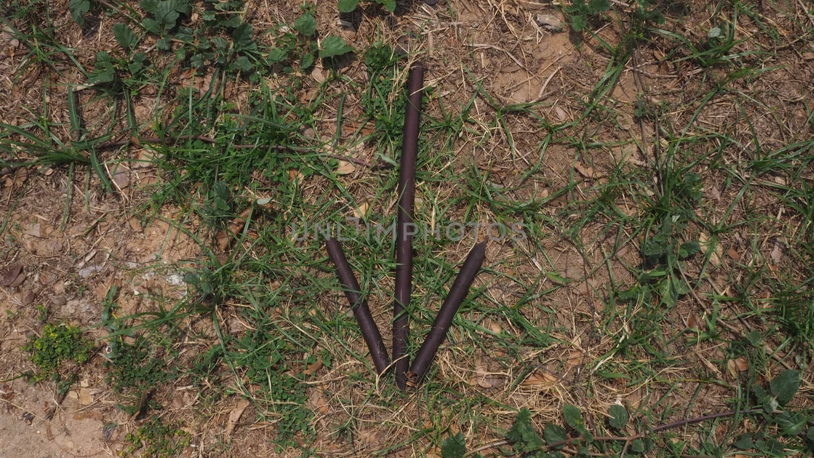 stick and grass arrow pointing down for survival skills or bushcraft or military sign, direction or signal by AndrewUK