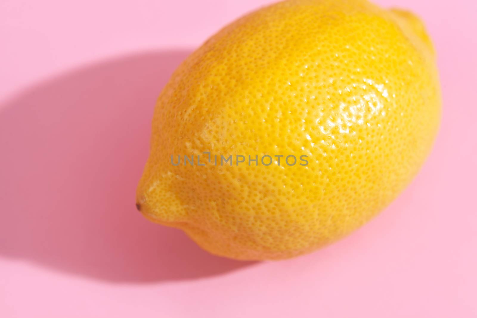 Trendy yellow lemon isometric pattern on pink background. Creative and modern minimal concept. Summer fresh flat lay food texture, copy space.