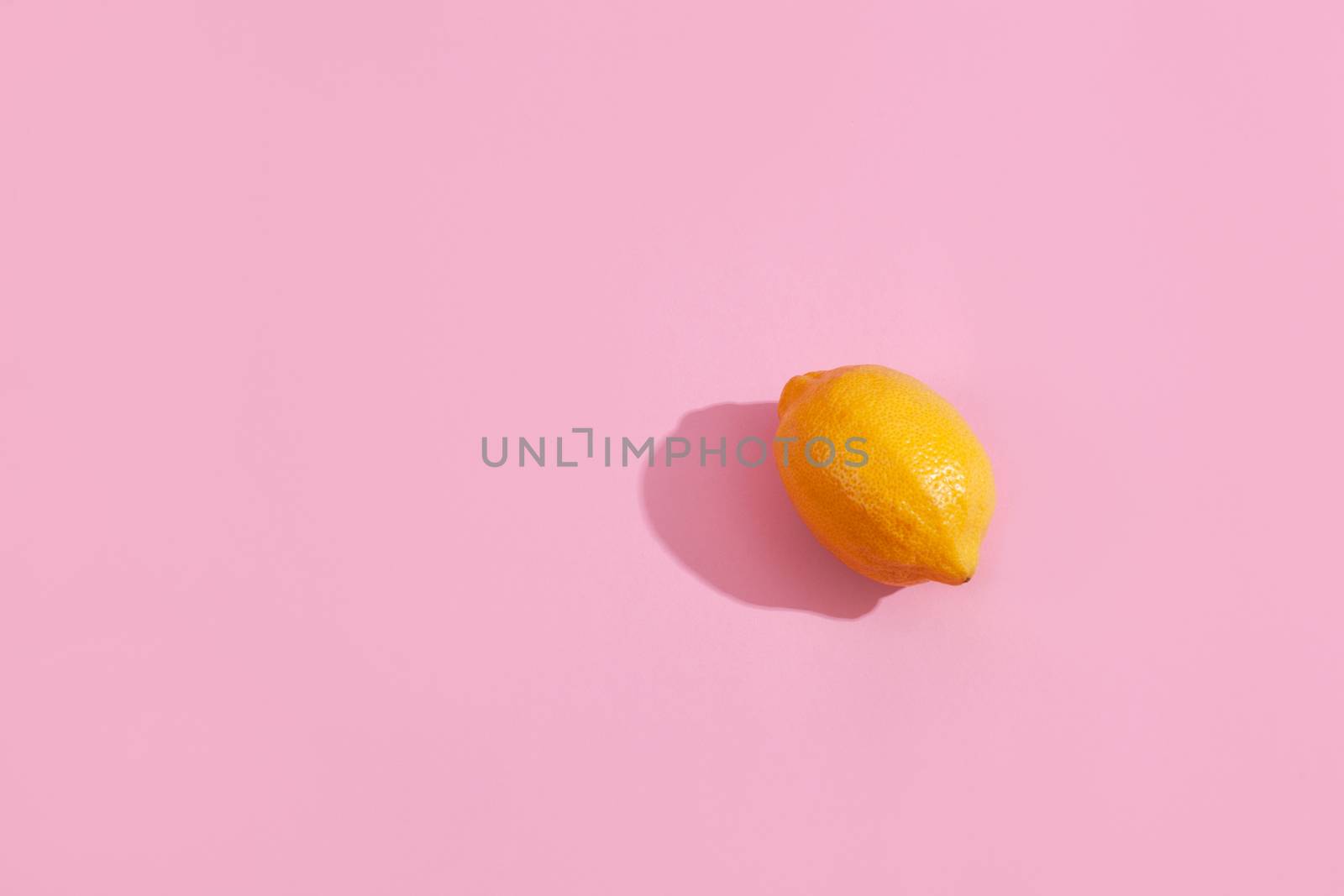 Trendy yellow lemon isometric pattern on pink background. Creative and modern minimal concept. Summer fresh flat lay food texture, copy space.