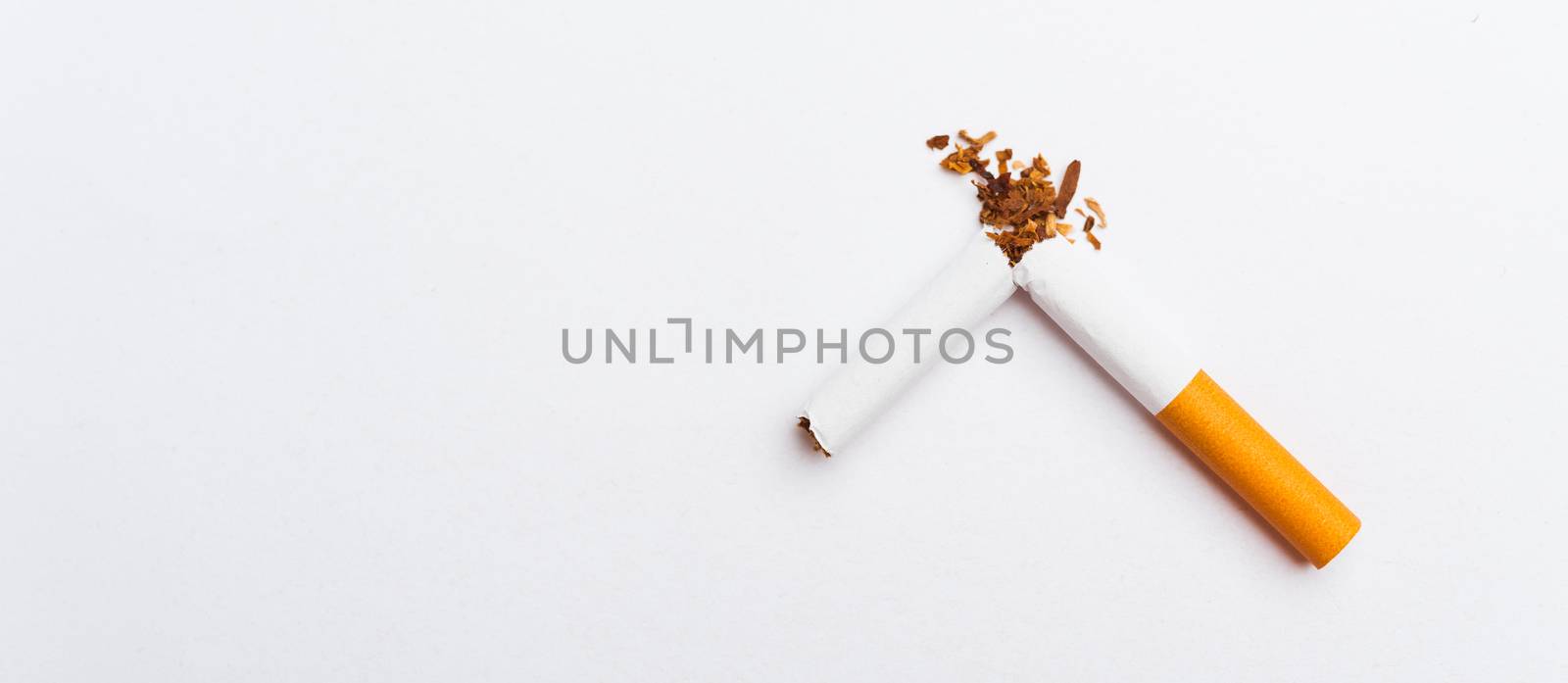 31 May of World No Tobacco Day, no smoking, close up of broken pile cigarette or tobacco STOP symbolic on white background with banner copy space, and Warning lung health concept