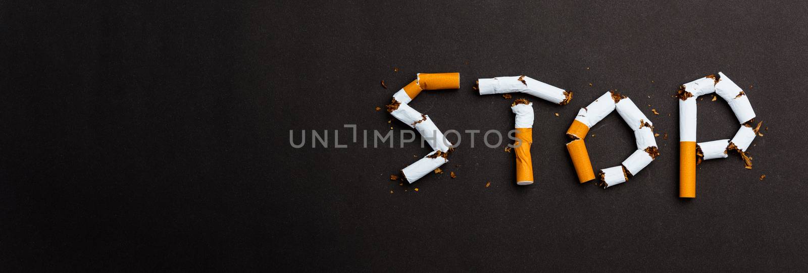 word STOP spelled text of the pile cigarette or tobacco by Sorapop