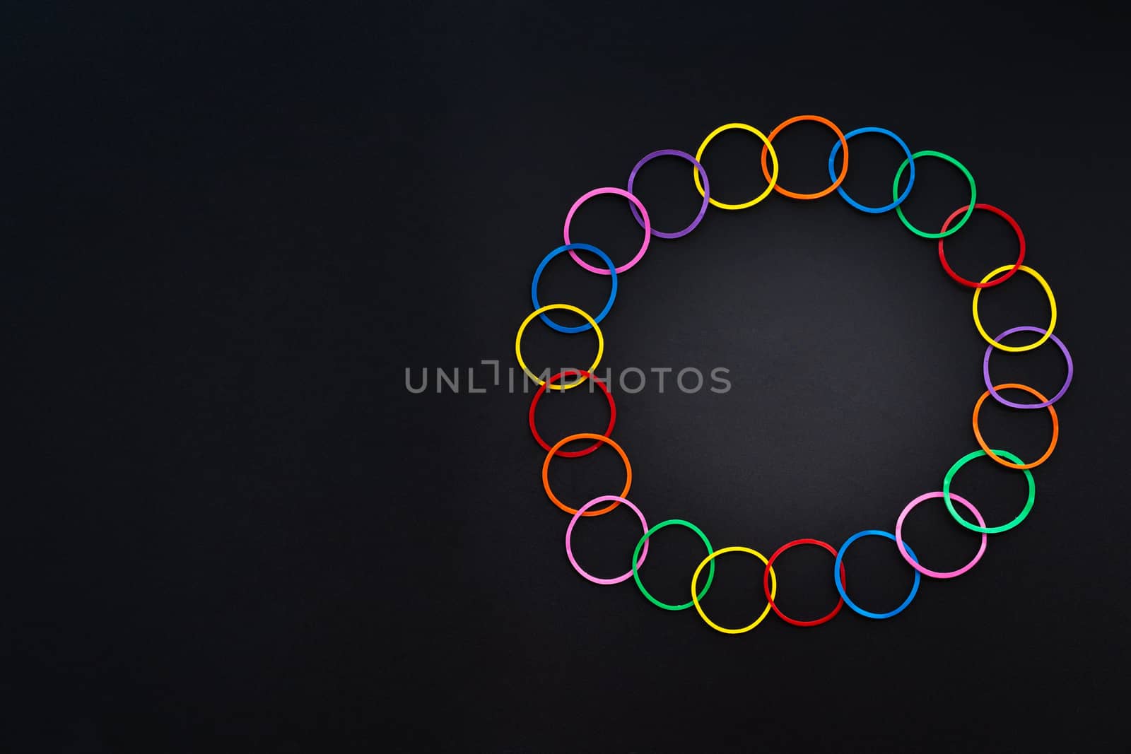 Teamwork concept. group of colorful rubber band on black background with copy space