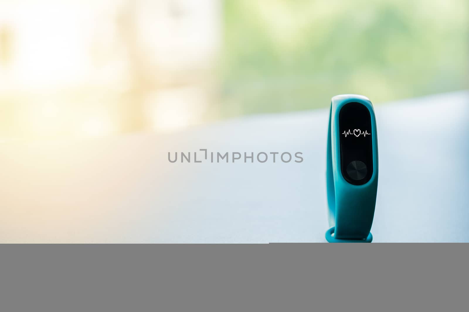 fitness smart band device blue color on black background with heart rate display
