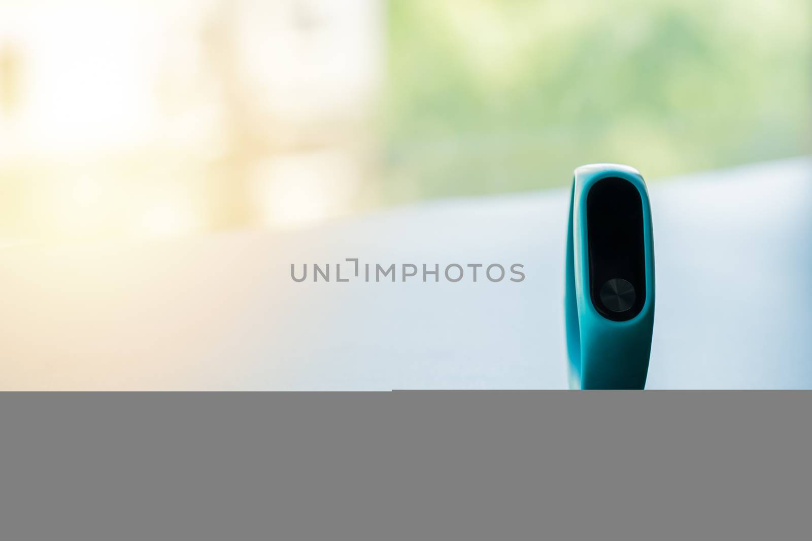 fitness smart band device blue color on black background, blank display with copy space