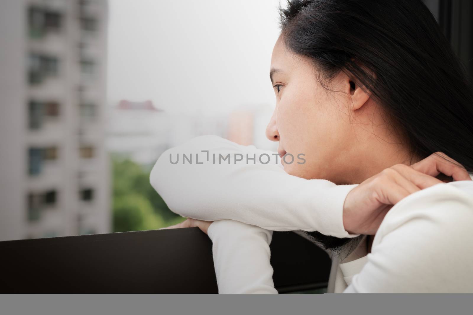 depressed women sitting near window, alone, sadness, emotional concept