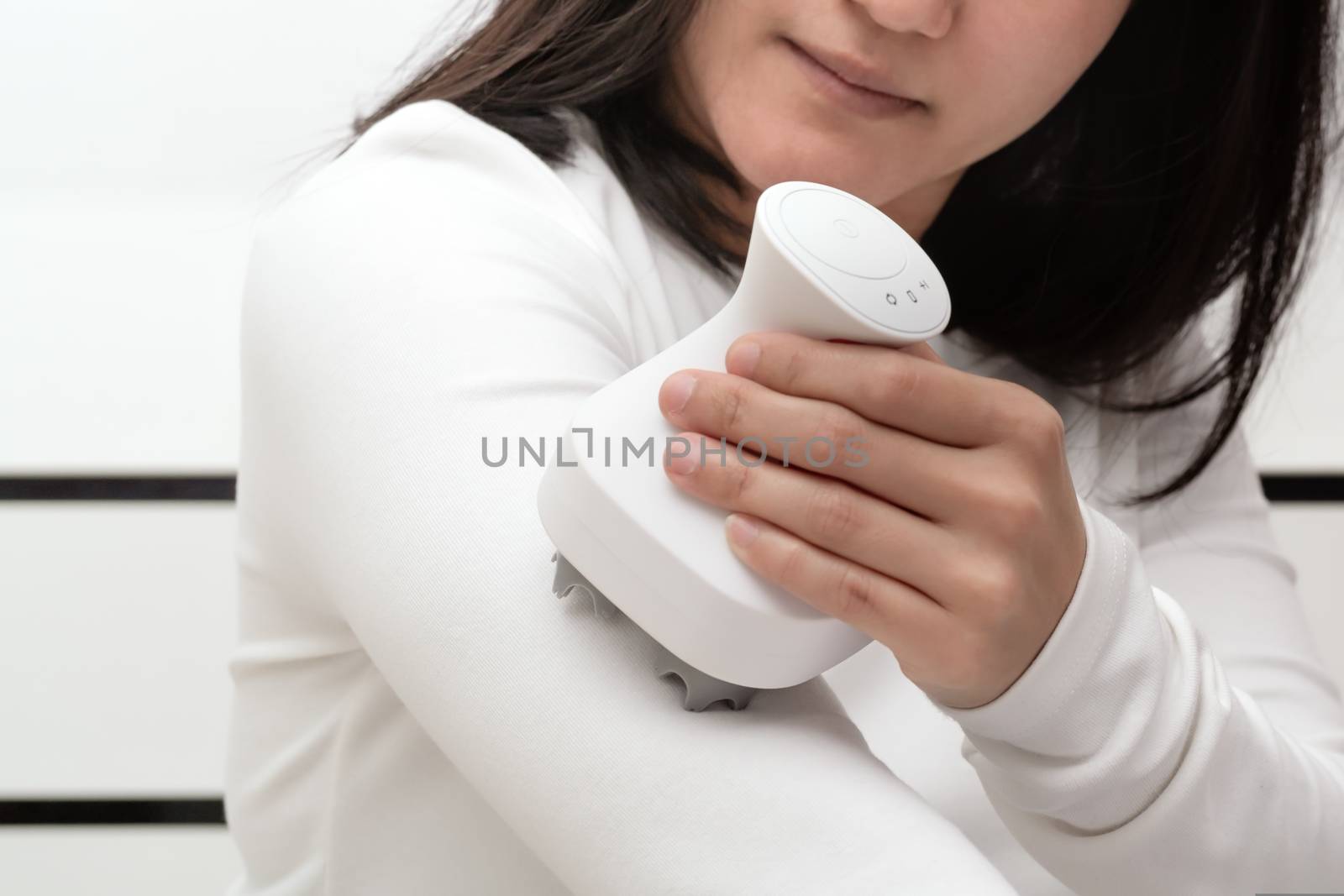 electric arm, neck and shoulder massage machine on women shoulder, closeup, healthcare and medicine concept