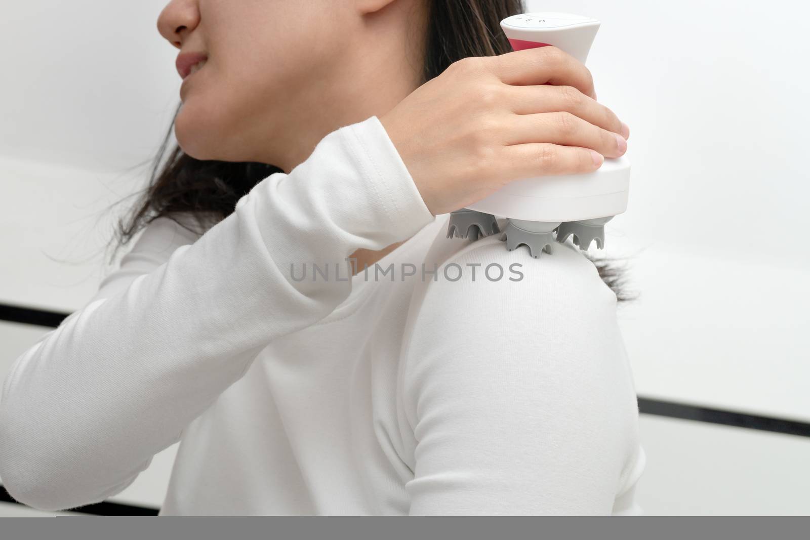 electric arm, neck and shoulder massage machine on women shoulder, closeup, healthcare and medicine concept