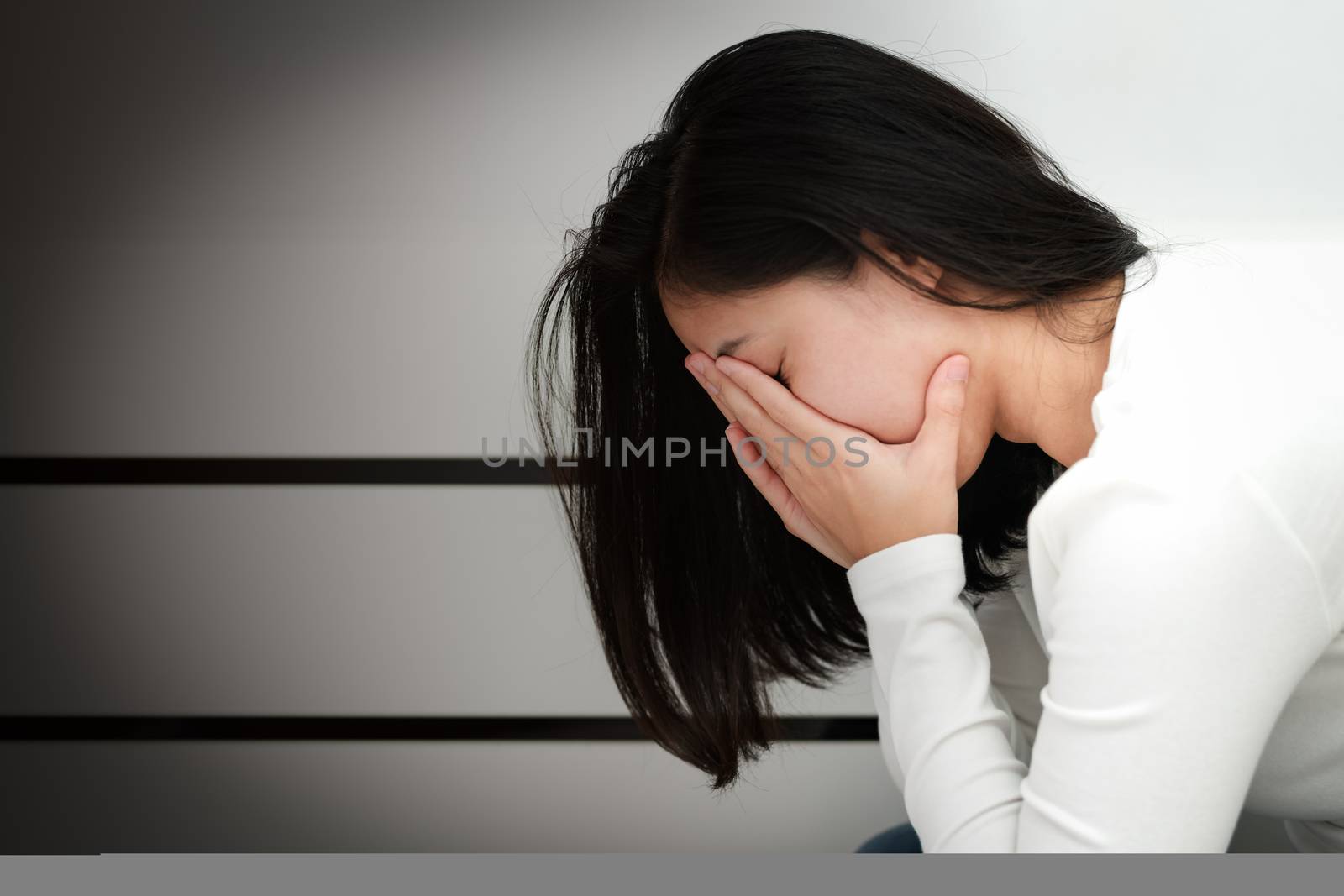 depressed women sitting in the corner of the room, alone, sadness, emotional concept