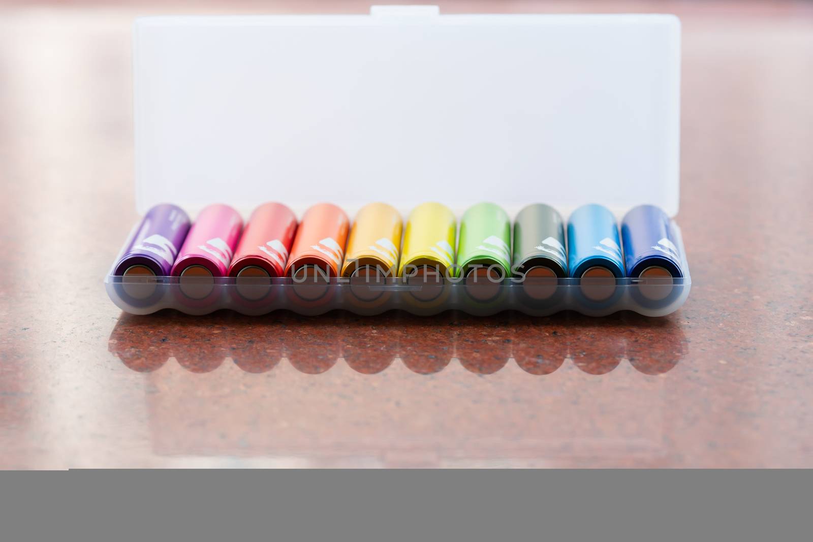 colorful of AA size batteries pile in white package