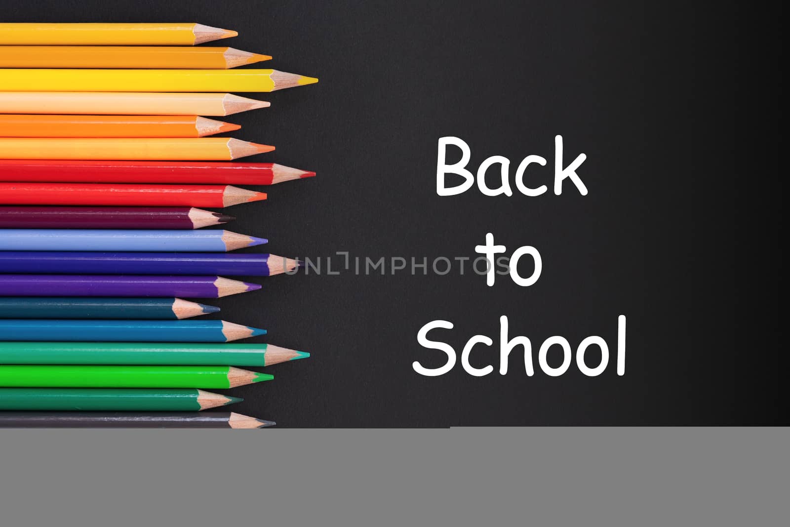 back to school Concept. Close up shot of color pencil pile pencil nibs on black background