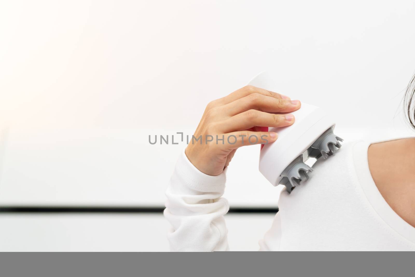 relax and massage, electric arm, neck and shoulder massage machine on women shoulder, closeup, healthcare and medicine concept