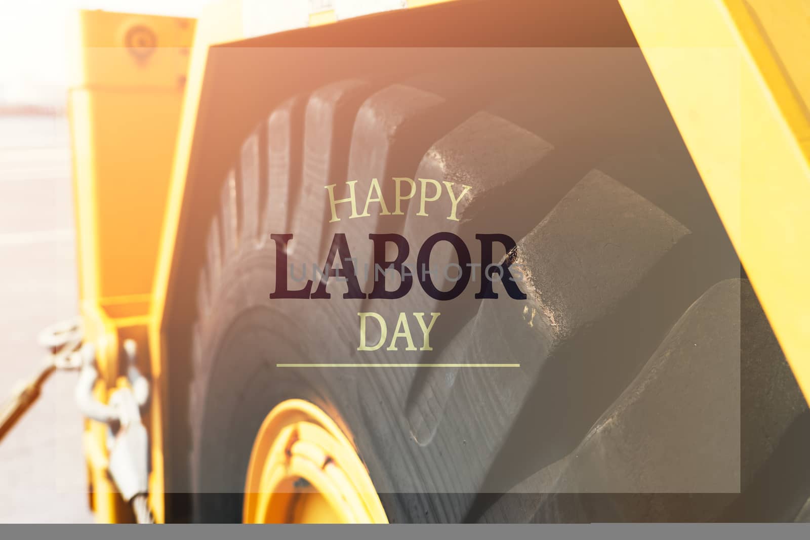 Labor Day Concept. excavator wheel closeup with word Happy Labor Day