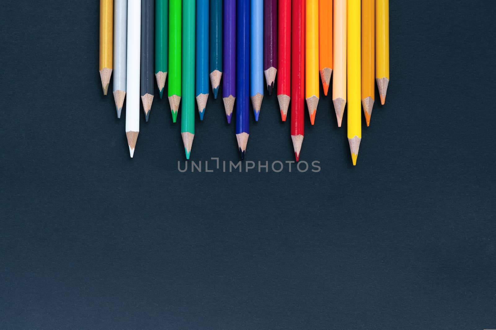 back to school Concept. Close up shot of color pencil pile pencil nibs on black background with copy space