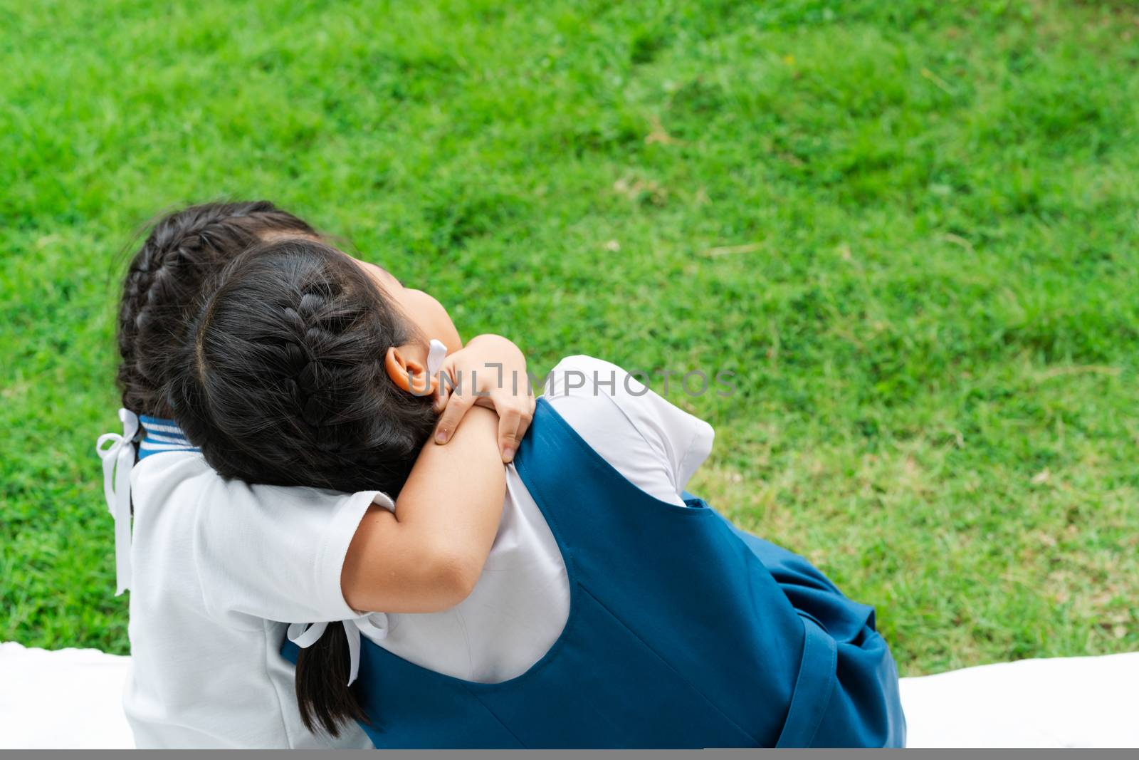 two little asian girls sisters hugging happy post in school uniform, back to school concept