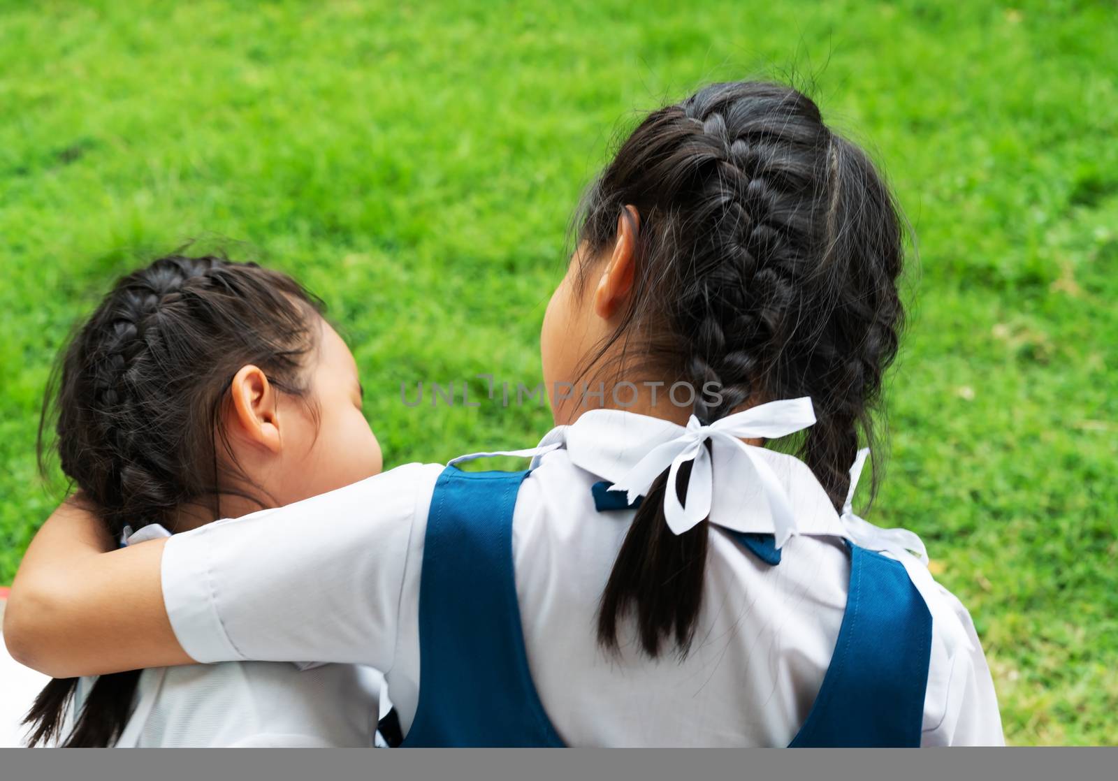 two little asian girls sisters hugging happy post in school unif by psodaz