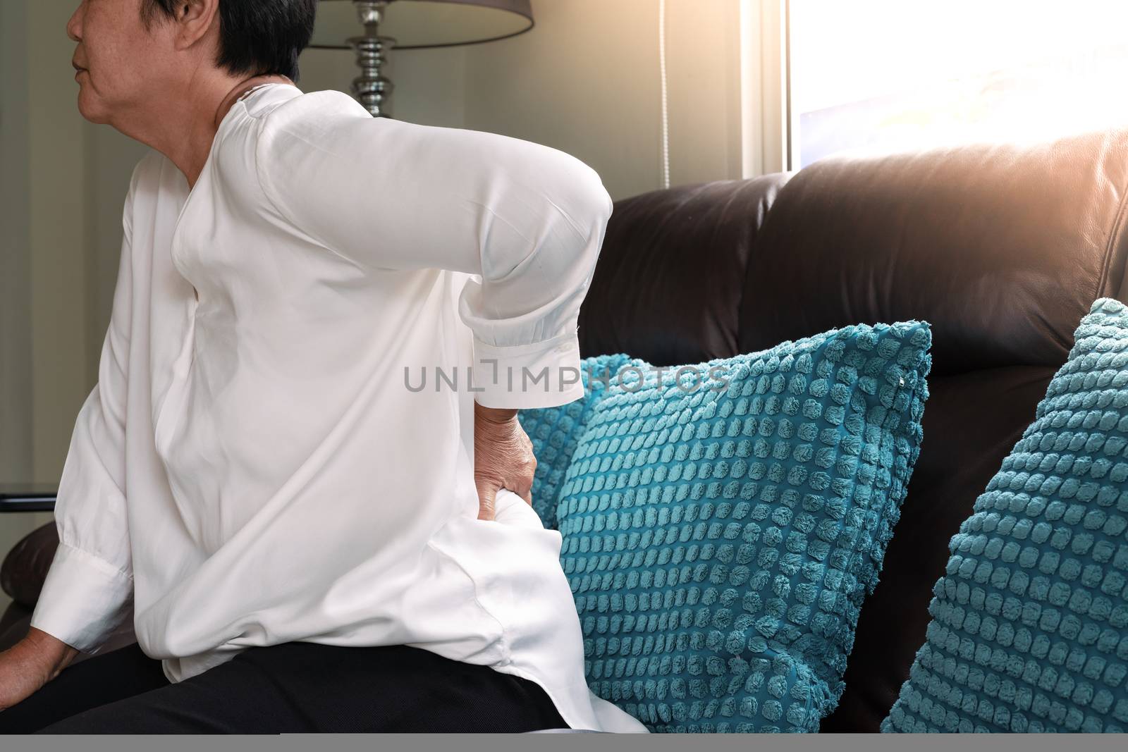 Old woman back pain at home, health problem concept