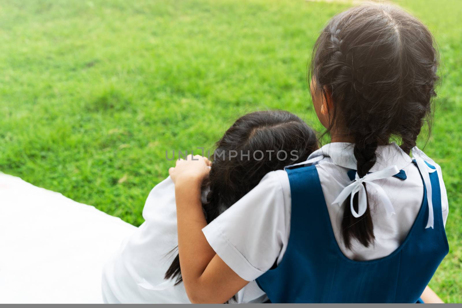 two little asian girls sisters hugging happy post in school uniform, back to school concept