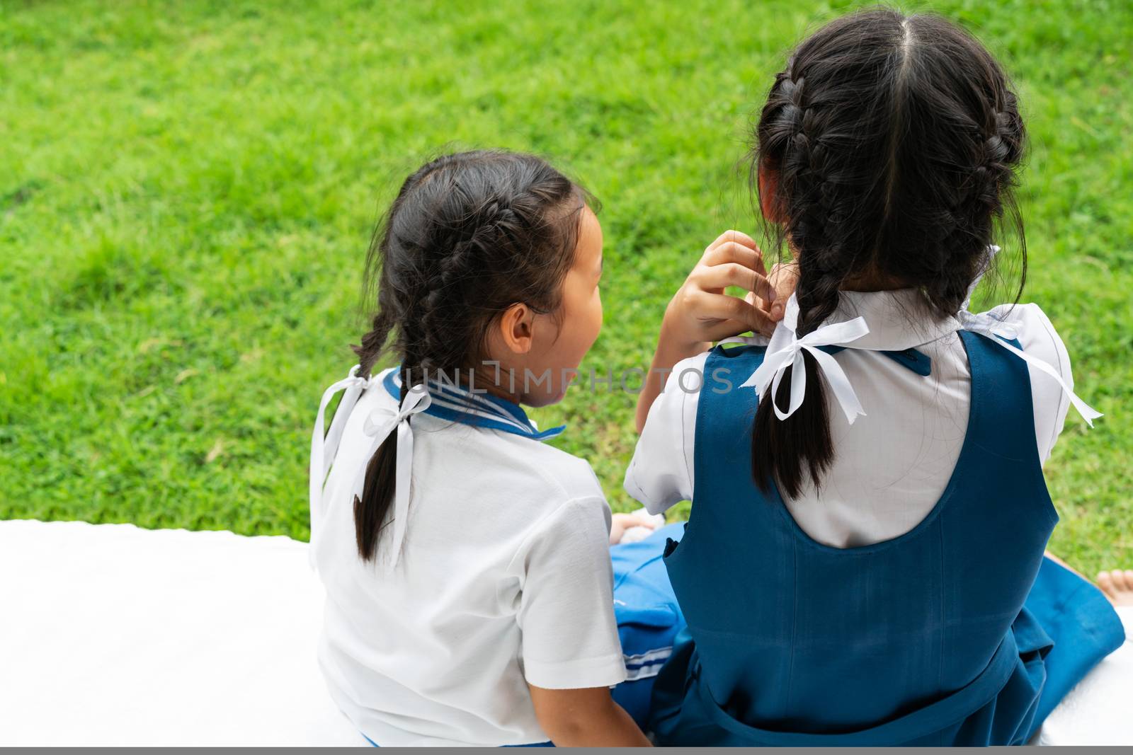 two little asian girls sisters hugging happy post in school unif by psodaz