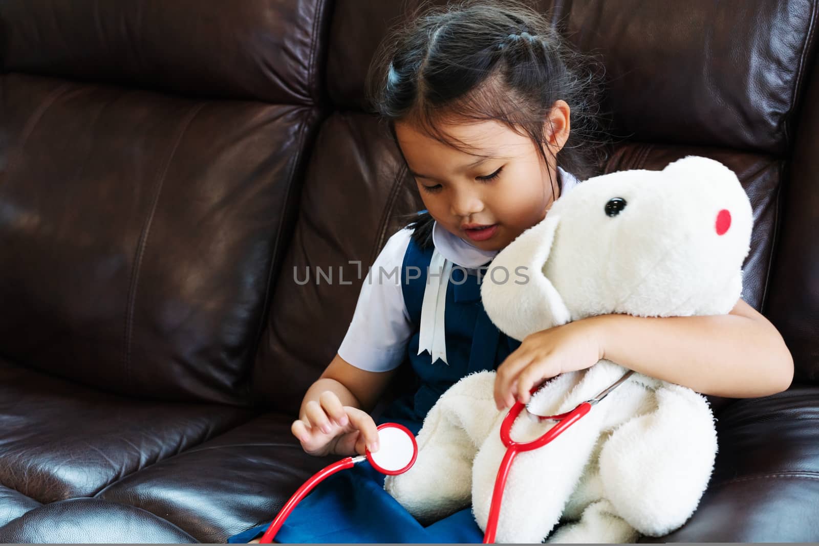 little girl are smiling and playing doctor with stethoscope. Kid and health care concept.