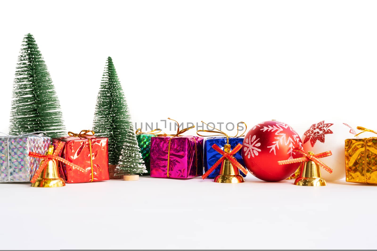 Christmas background concept. Christmas gift box and tree with golden bells, pine cones, red and white ball on white background