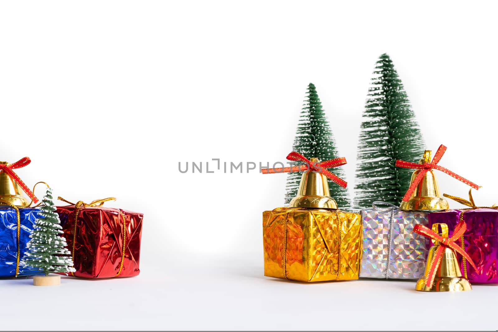 Christmas background concept. Christmas gift box and tree with golden bells, pine cones, on white background