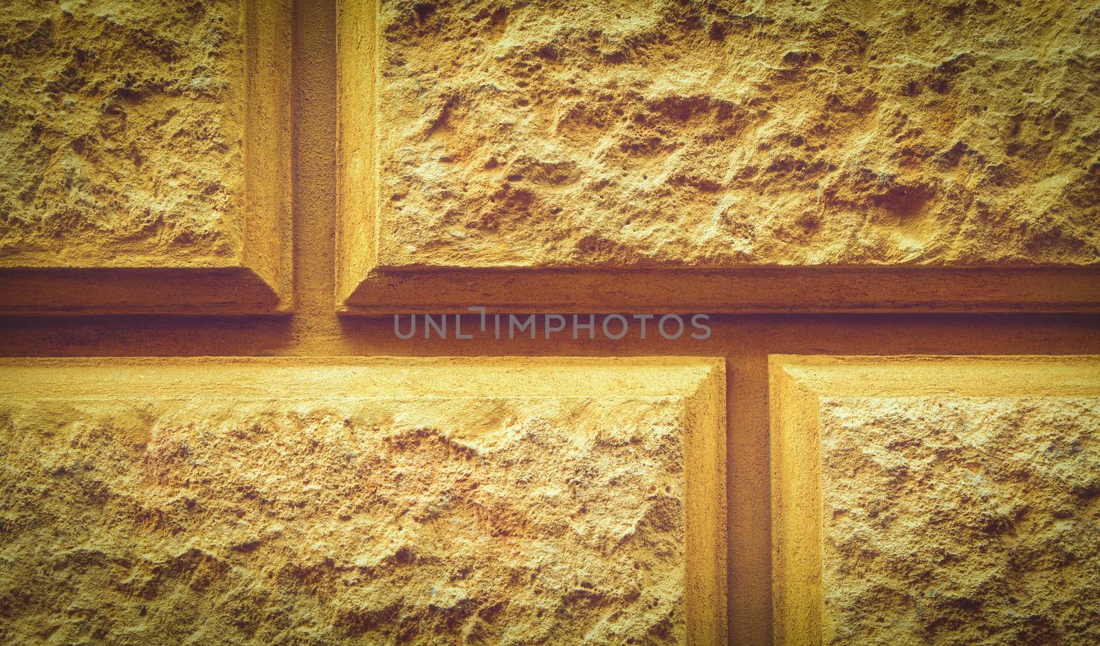 Close up of a beige stone tiled texture with a pattern. Textured background of decorative limestone bricks. Stone wall design background.