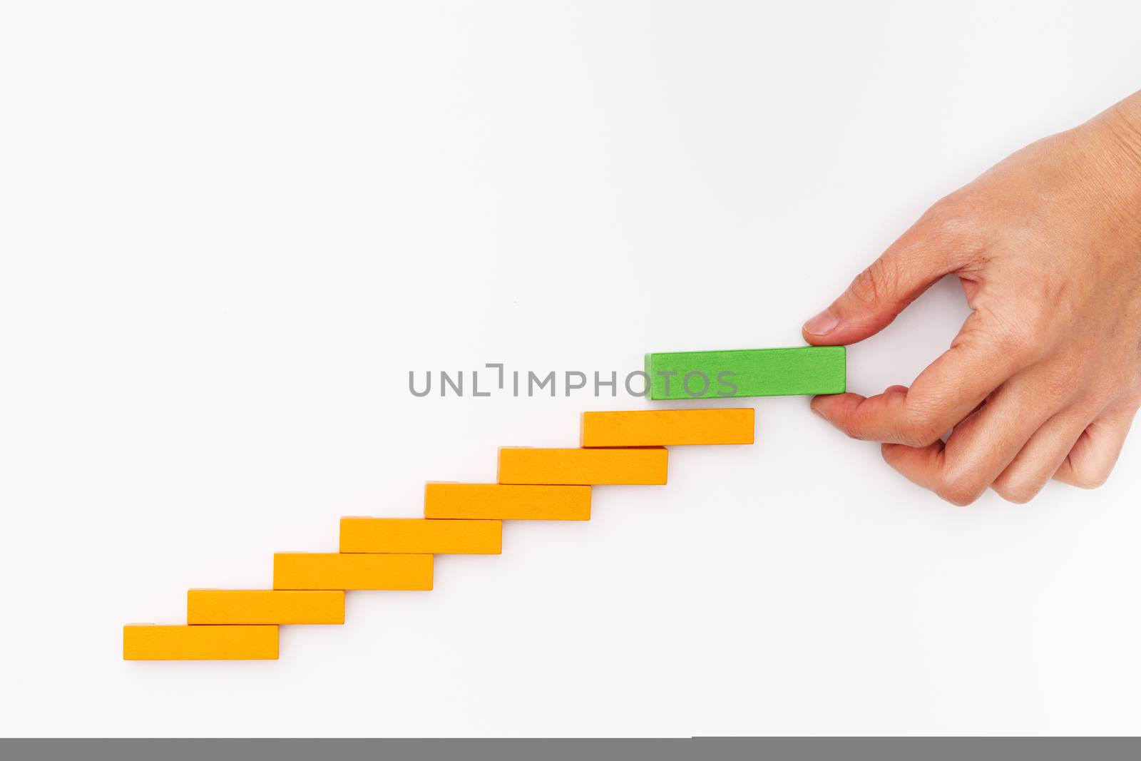 Business concept for growth success process, hand stacking wood block as step stair