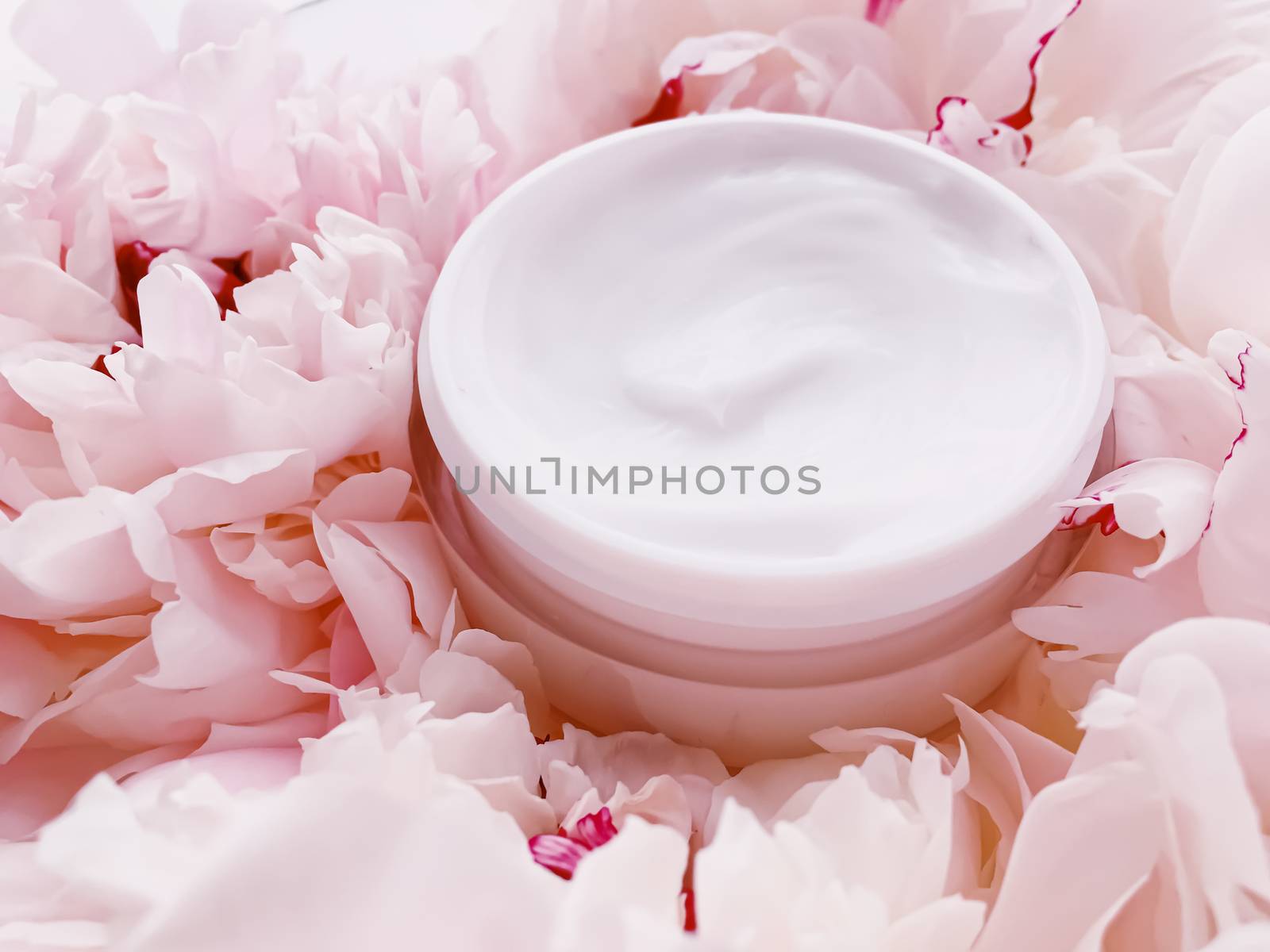 Face cream moisturizer on floral background as luxury skincare cosmetics, healthcare and beauty product concept