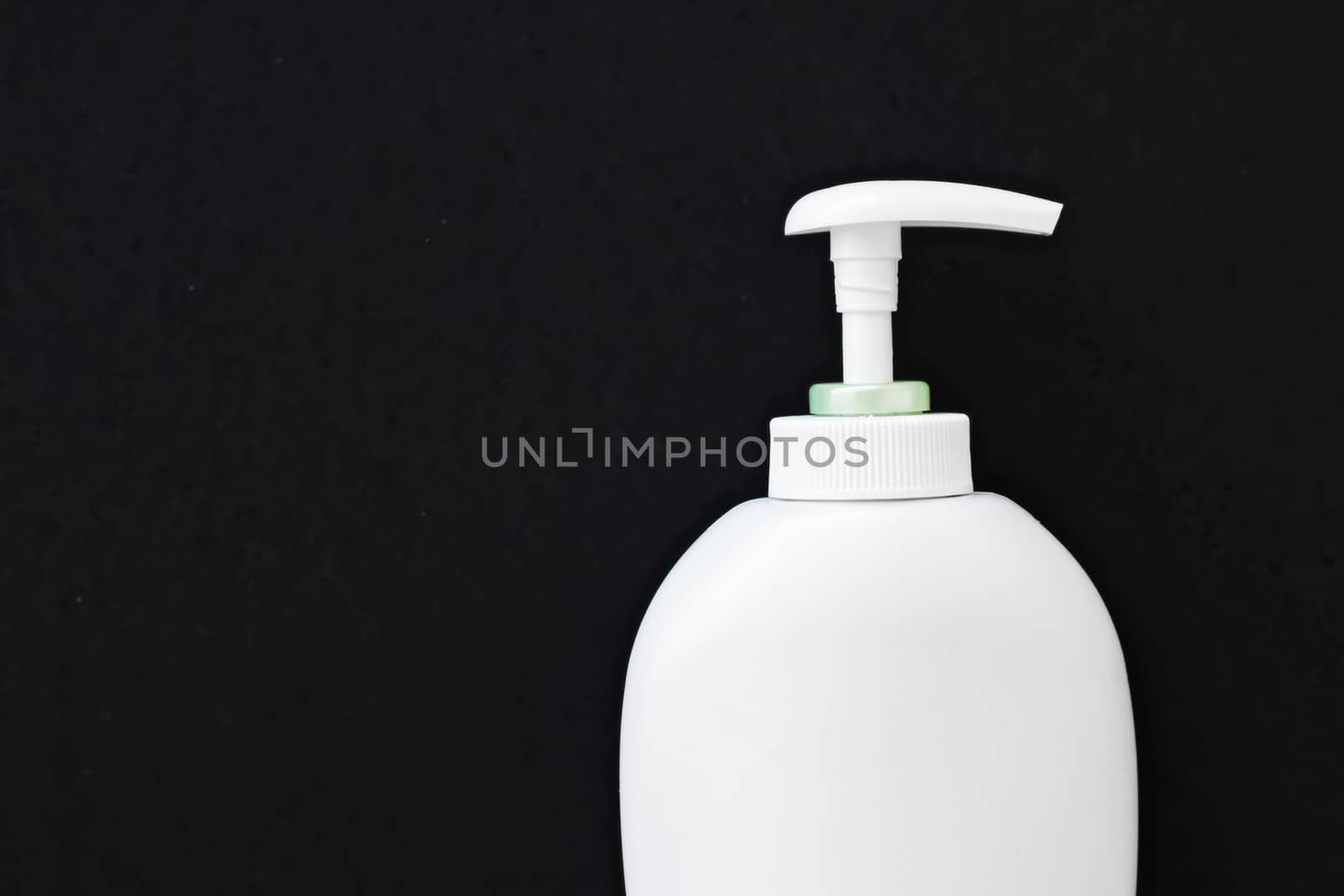 Blank label cosmetic container bottle as product mockup on black background, hygiene and healthcare