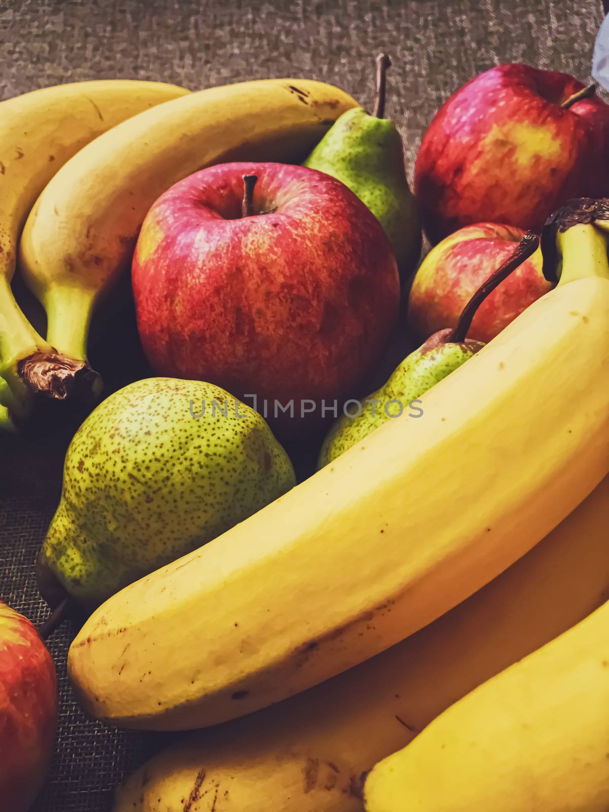 Organic apples, pears and bananas on rustic linen background by Anneleven