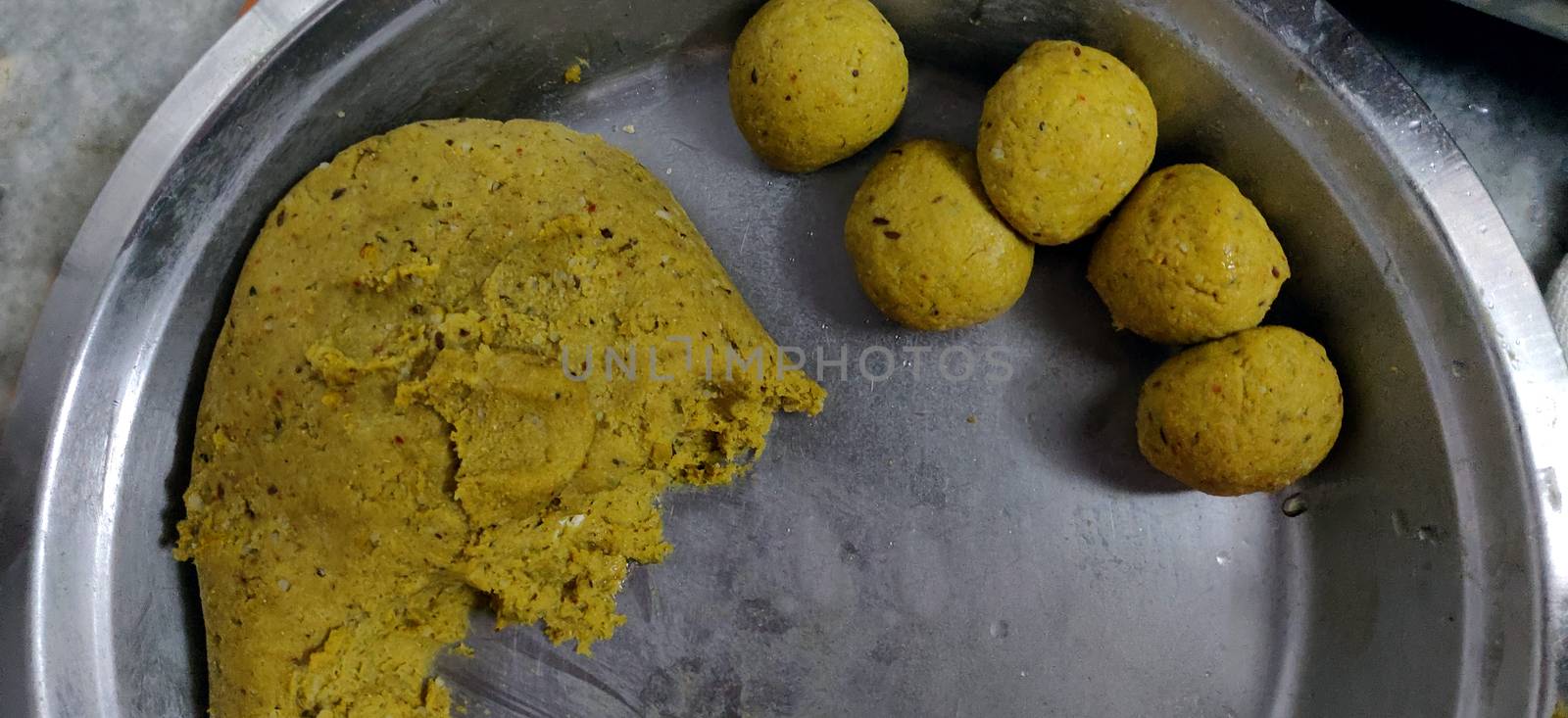 Puri (also Poori), a deep-fat fried bread made from unleavened whole-wheat flour that originated in the Indian subcontinent, in progress dough.