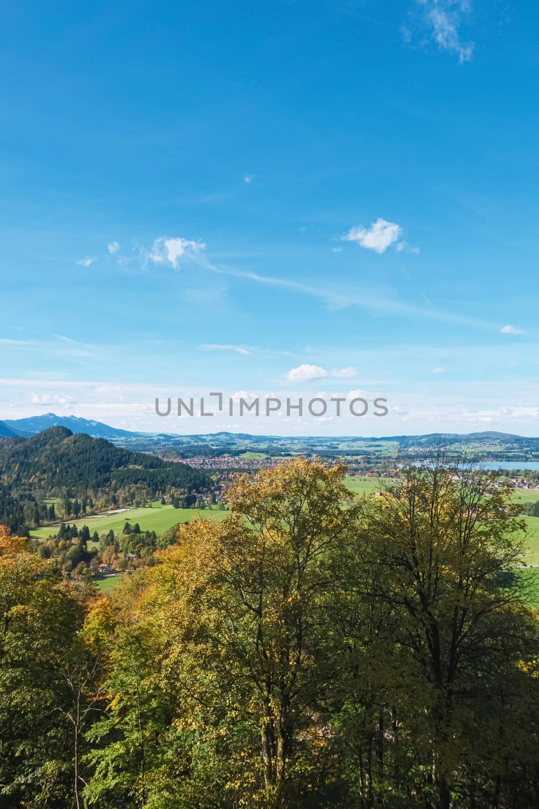 Beautiful nature of European Alps, landscape view of alpine mountains, lake and village on a sunny day, travel and destination scenery