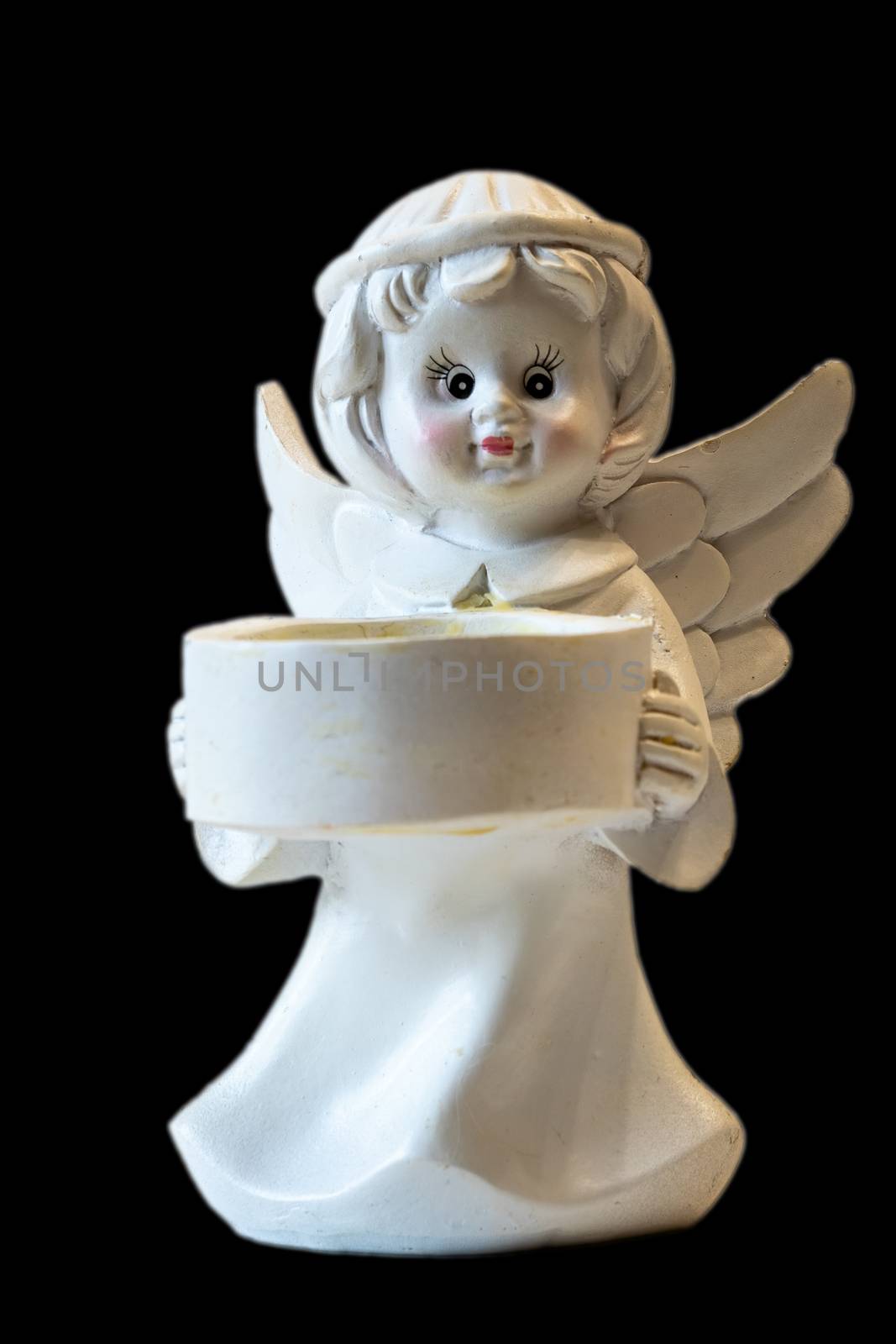 White ceramic angel figurine isolated on black background. Angel figurine for concept design. The concept of love and kindness.
