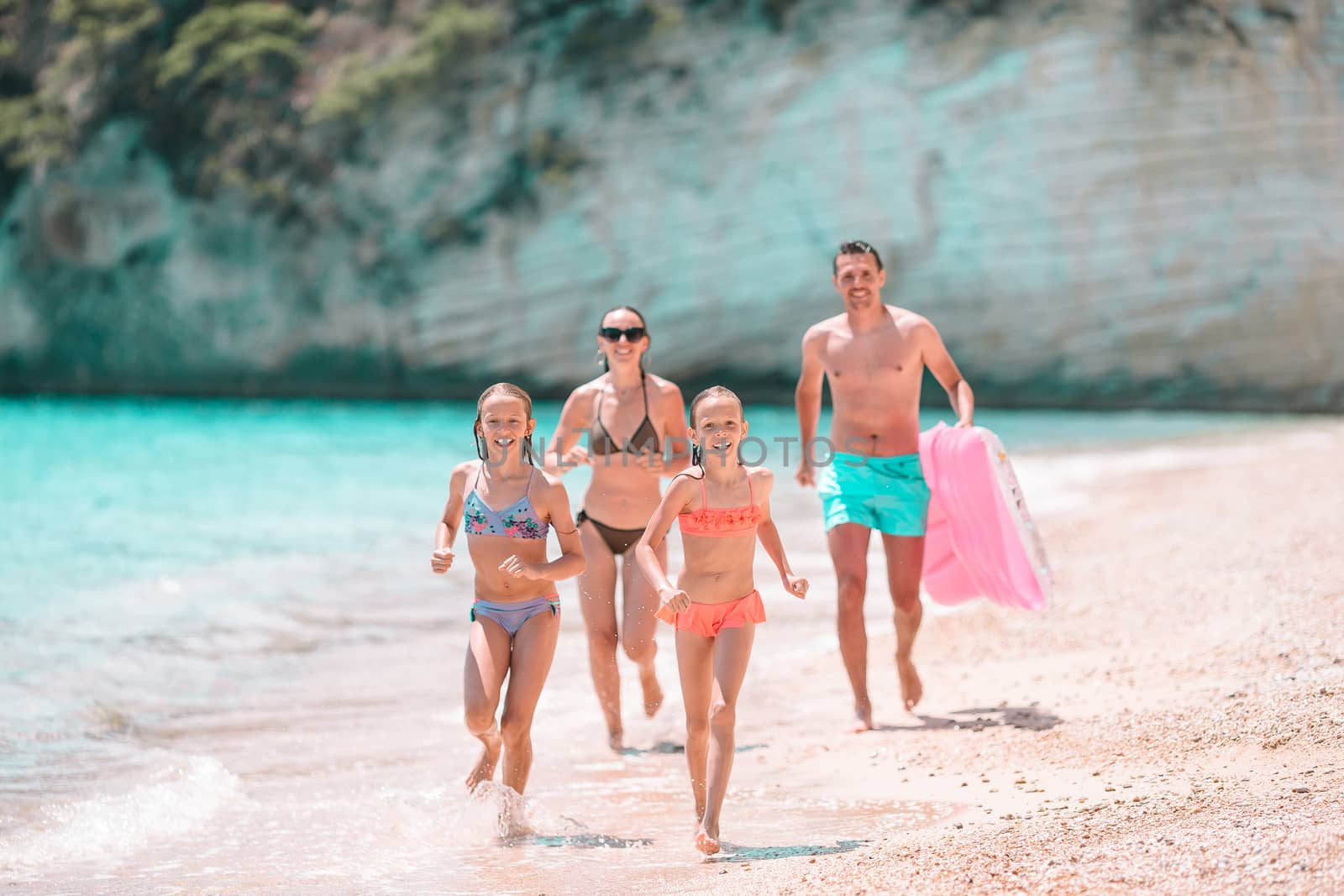 Photo of happy family having fun on the beach. Summer Lifestyle by travnikovstudio