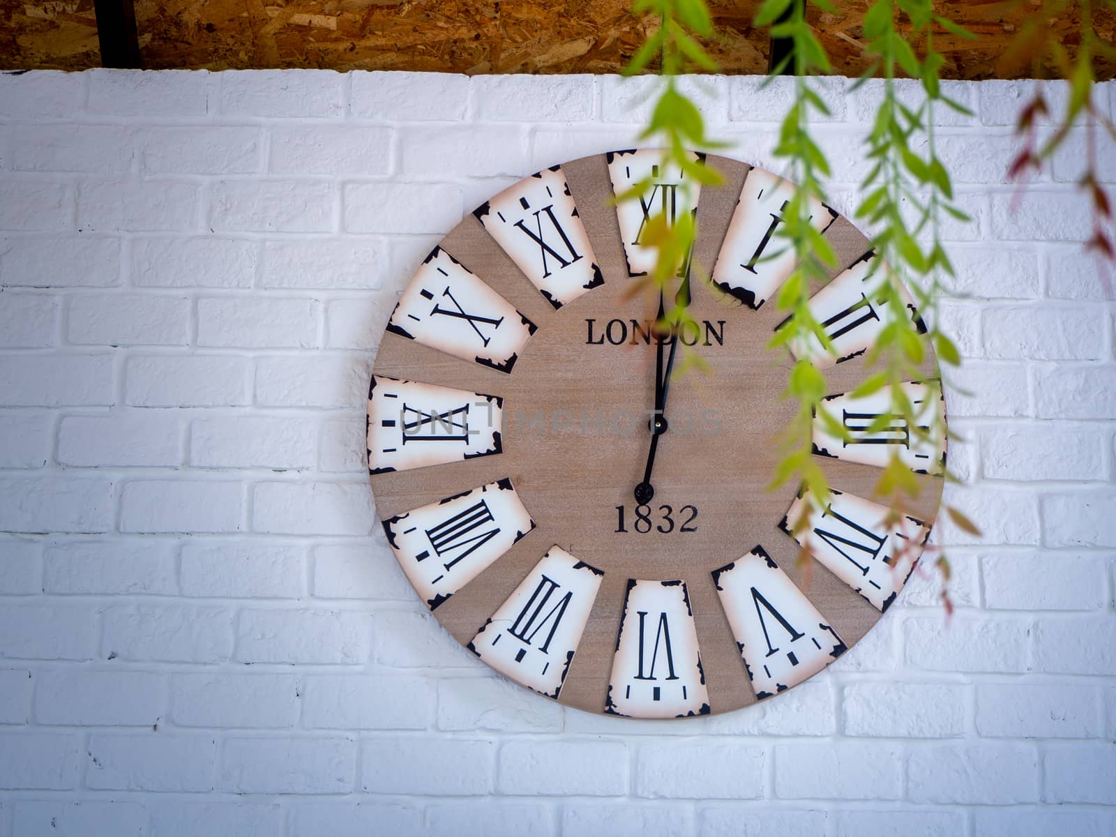 retro wall clock distressed and weather worn with Roman numerals by shutterbird