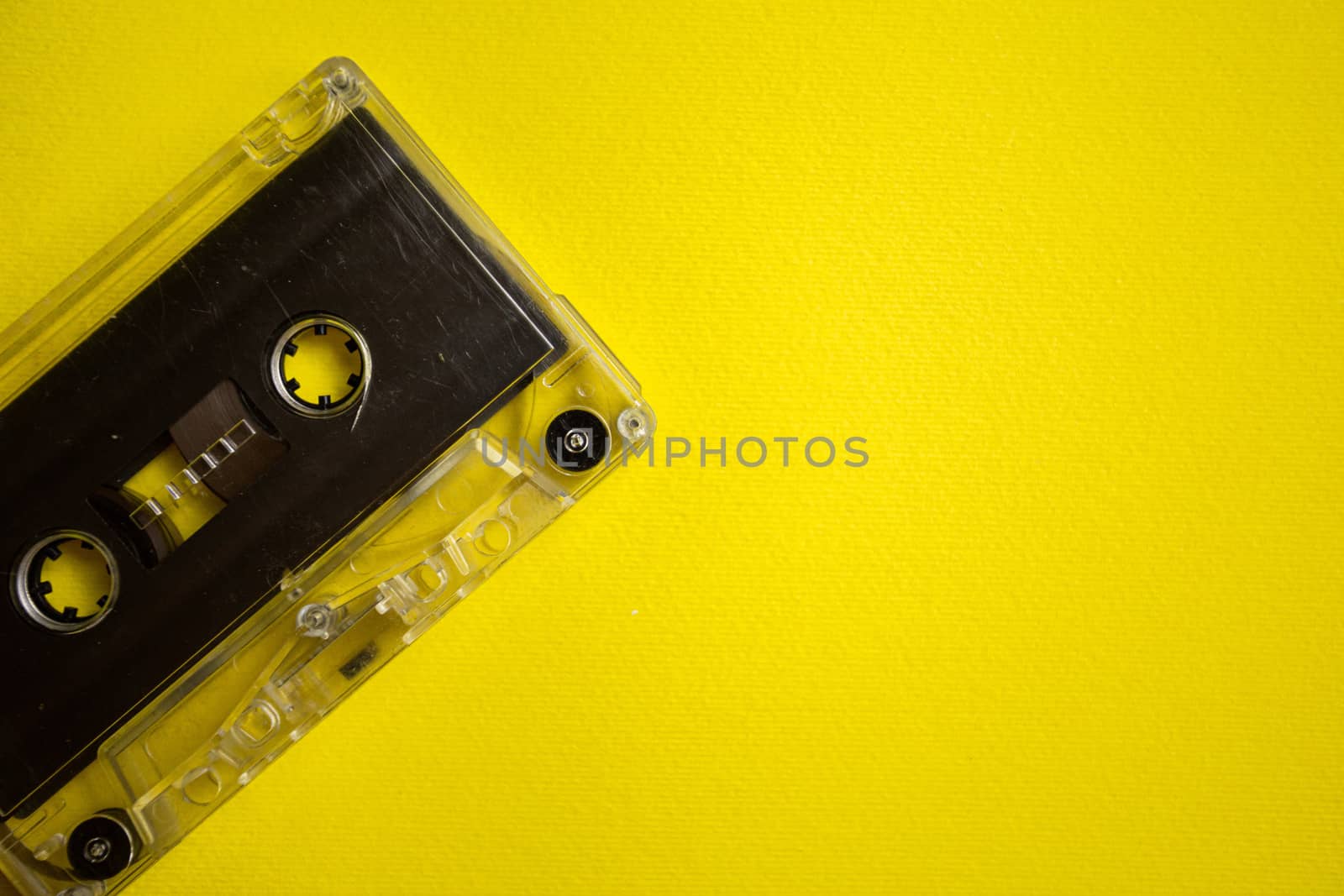 Retro audio cassette on a yellow background, music