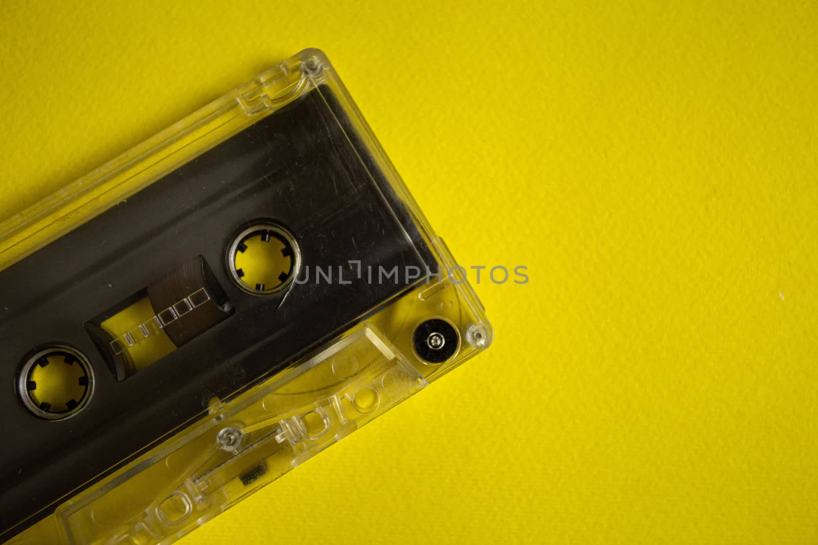 Retro audio cassette on a yellow background, music