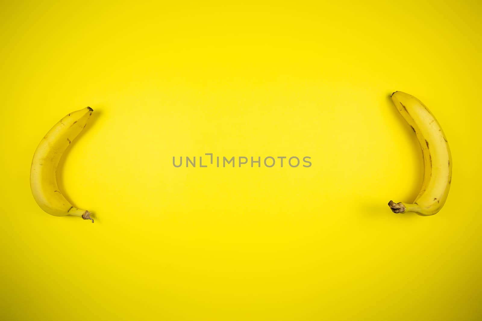 Ripe banana on a yellow background, fruits